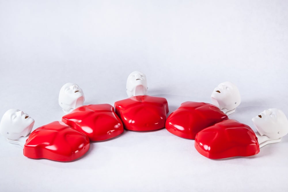 Collection of five plastic dummies on white background